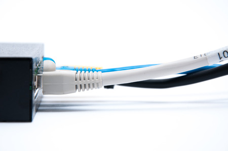 Grey, blue and black cables, connected to the network hubの写真素材