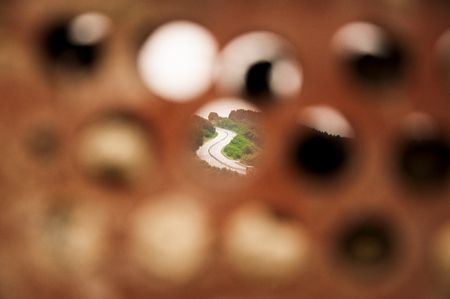 View on the highway through the hole in the brickの写真素材