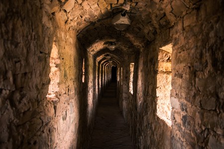 Dark tunnel with small windows in the castleのeditorial素材