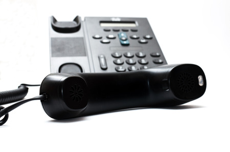 Black handset and a phoneの写真素材