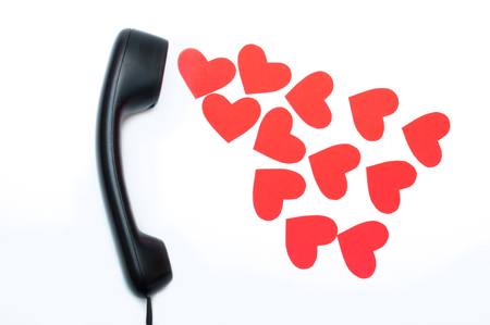 Black phone headset with many carton heartsの写真素材