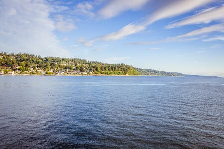 Green island in the ocean with beautiful blue skyの写真素材