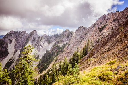 High rocky mountains under the rainy clouds