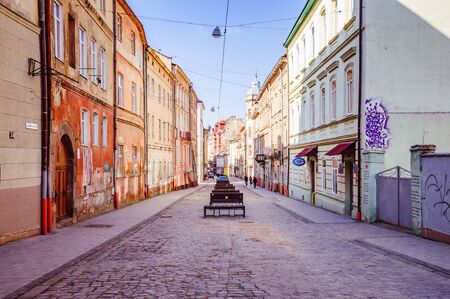 Narrow street with old buildings and pavement roadの写真素材