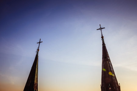 Peaks of gothic cathedral with blue sky during the sunset on the background