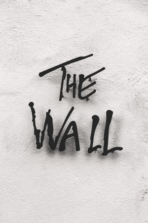 Black metal inscription "The Wall" on the facade of white buildingの写真素材