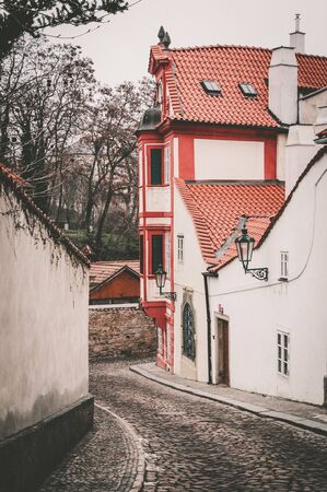 Old narrow street with an ancient building in Pragueの写真素材