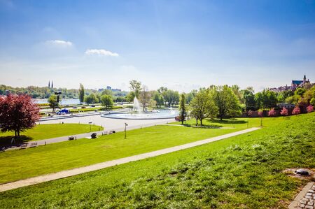 Green lawn in the central part of the city with a blue sky on the backgroundの写真素材