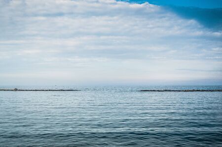 View on the calm sea in the evening on hte border with Italyの写真素材