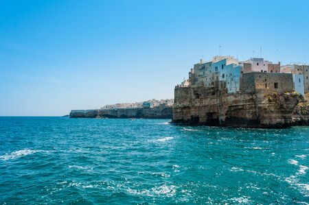 Ancient buildings on the rocks surrounded by sea waterの写真素材
