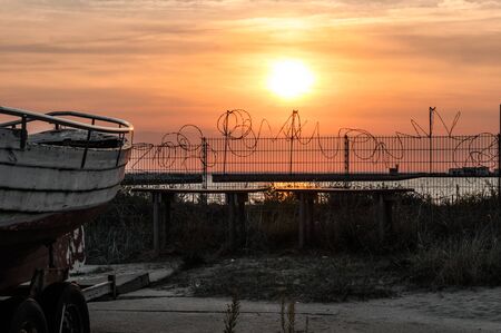 Metal fence in the rays of sunsetの写真素材
