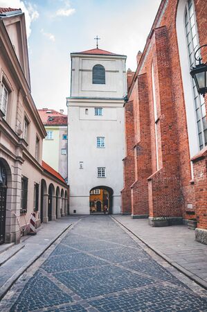Narrow street leading to an ancient white cathedralの写真素材