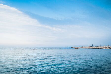 View on the calm sea in the evening on hte border with Italyの写真素材