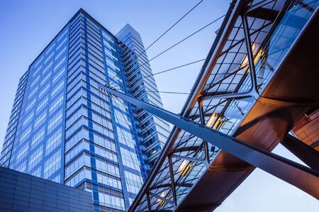 Modern skyscraper and glass bridge in the business area of the cityの写真素材