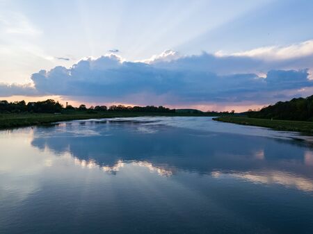 Drone shot of the spectacular sunset behind the cloudwith sun rays going into the skyの写真素材