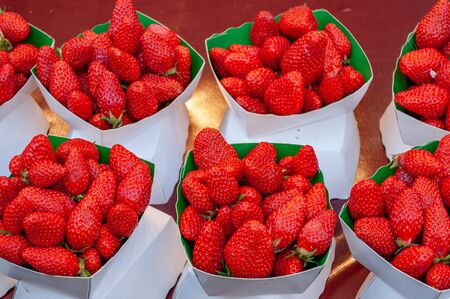 Beautiful fresh and juicy strawberries on the table in one of the oldest stores in Parisの写真素材