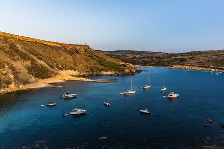 Blue calm water of the Malta bay with pure sky on the backgroundの写真素材