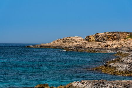 Blue clear sea water on the coast line on Maltaの写真素材