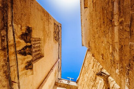 Clear blue sky between old historical buildings in the southern part of Italyの写真素材