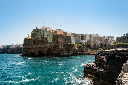 Ancient buildings on the rocks surrounded by sea waterの写真素材