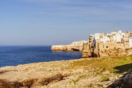 Small local town in Italy on the sea coast with white houses based on rocksの写真素材