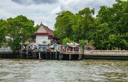 Poor district of Bangkok with wooden houses on the riverの写真素材