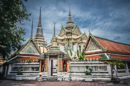 Ancient buddha temples complex in the historical part of Bangkok with rainy clouds on the backgroundの写真素材