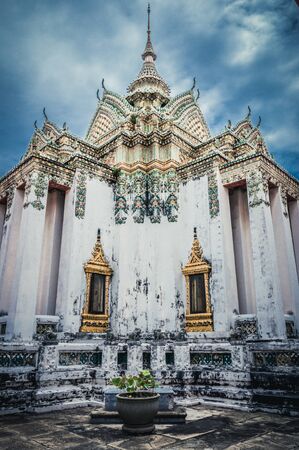 White ancient buddha temple in Thailand with rainy clouds on the backgroundの写真素材