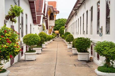 Narrow street between white houses in Bangkokの写真素材