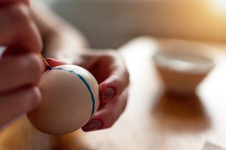 easter egg painting in dark blue colorの写真素材