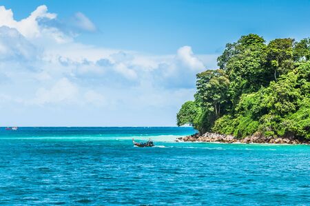 Green tropical island in the middle of the oceanの写真素材