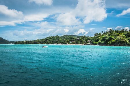 Green island in the middle of the oceanの写真素材
