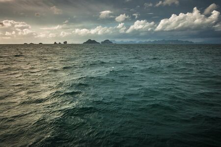 Water of the ocean colored by sunset reflectionの写真素材