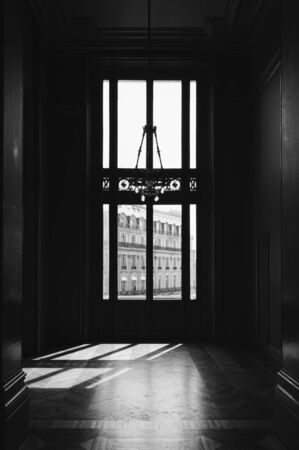 Sun rays on the floor of a big dark roo, with huge windowの写真素材