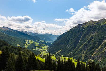Green grass of a magic valley in Alps on a sunny dayの写真素材