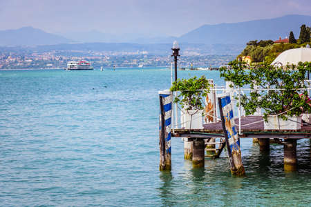 Wooden pier of a restaurant on the Lago di Gardaの写真素材