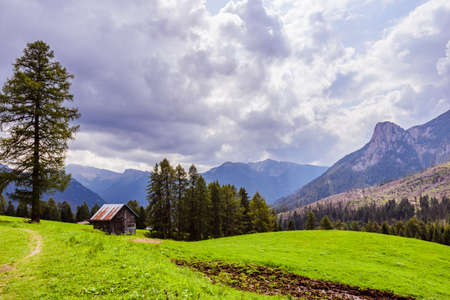 Green valley in Dolomites with heavy clouds on the backgroundの写真素材