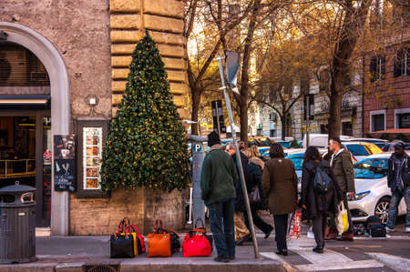 Rome, Italy - Dec 25, 2017 - Young guy is trying to sell fak bags from knwon italian brandsのeditorial素材