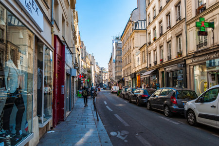 Paris, France - Apr 20, 2019 - Narrow street in Paris among old buildings and fully parked roadsのeditorial素材