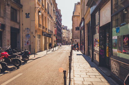 Paris, France - Apr 20, 2019 - Narrow street in Paris among old buildings and fully parked roadsのeditorial素材