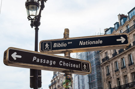 Paris, France - Apr 21, 2019 - Black touristic signs for Passage Choiseul and National Library near...