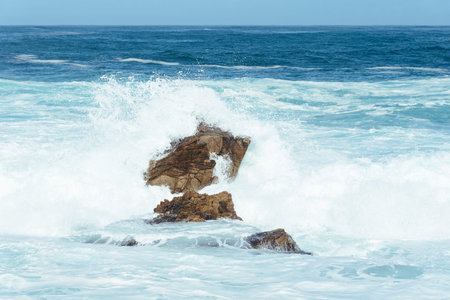 White foam from ocean water hitting the rocks