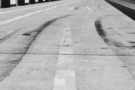 Abstract black and white photo of asphalt road with marking lines on surface.の写真素材