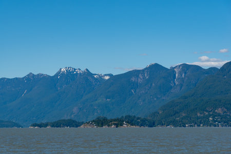 Landscape of the lake and mountains on a background of blue skyの写真素材
