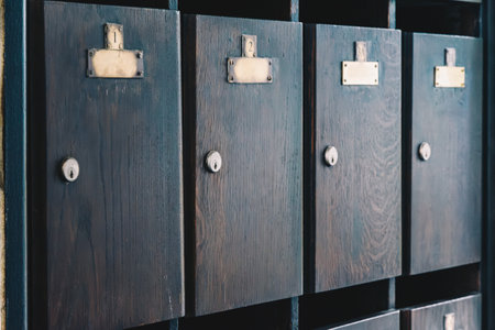 Wooden mailboxes with empty metal plates and numbersの写真素材