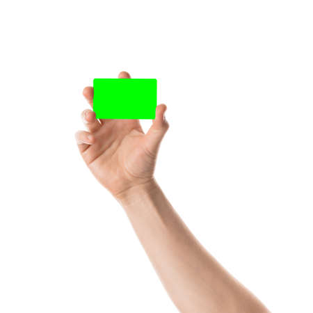 Male hand holds a credit card or business card. Isolated with chroma key and all isolated on white background.の写真素材
