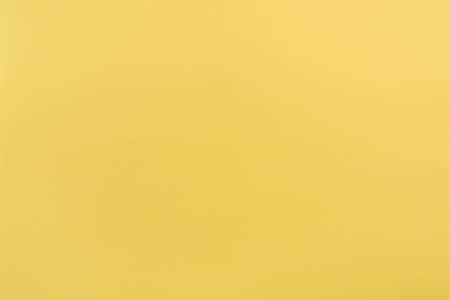 Yellow paper with soft texture. Simple background.の写真素材