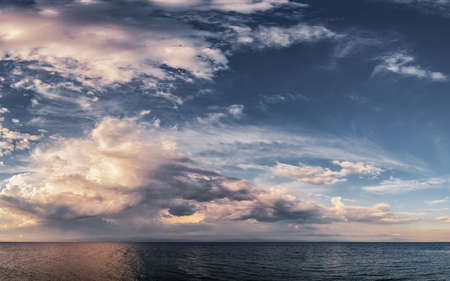 Dramatic sunset at the open sea, panoramic sky over the Aegean sea, peninsula Kassandra, Greece.の写真素材