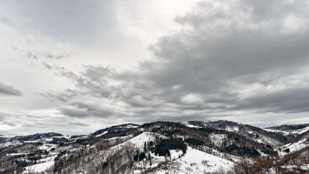 Mountain Zlatibor, Serbia at winter. Beautiful landscape in winter, a snow covered mountain, dramatic cloudy sky.の写真素材