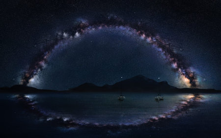 Milky Way panorama on the open sea with two lonely boats, astro night photography.